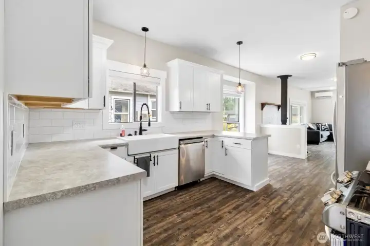 Another view of the kitchen and open living spaces