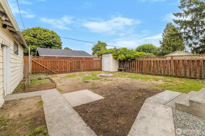 Back yard. Double doors in very back, garden shed in the back on right.