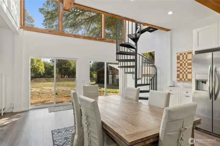 Bright dining area with picture window views of the property.