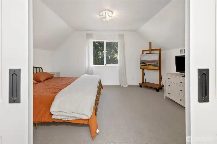 Another view of the additional bedroom with vaulted ceilings.