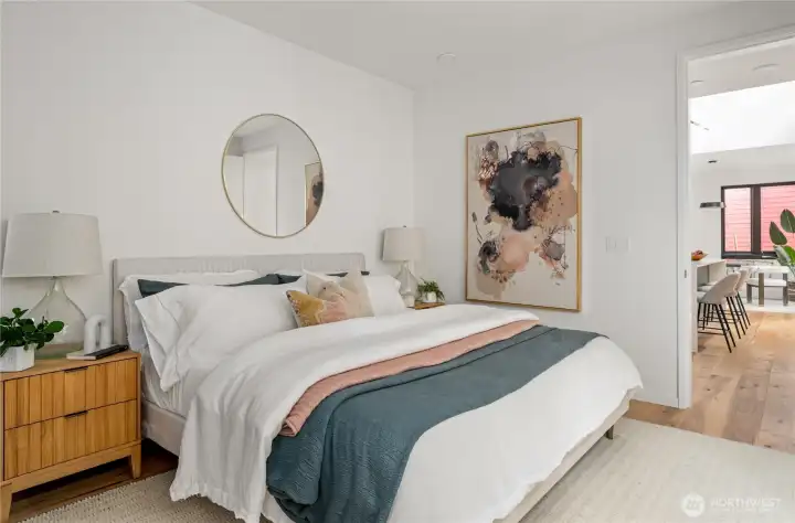 The main floor primary suite offers ultimate convenience and luxury, featuring an ensuite bathroom and an entire wall of built-in Abodian closets for exceptional storage and organization.