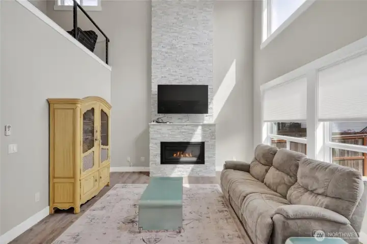 Floor to ceiling tiled fireplace, with gas insert. Great natural light!