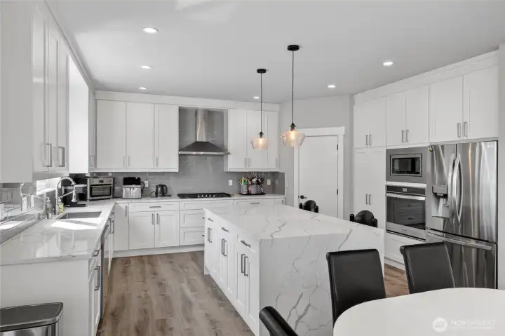 The cabinets go all the way to the ceiling! Gas range and built-in oven and microwave.
