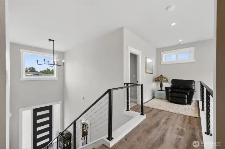 Upstairs is light and bright, with modern railings.