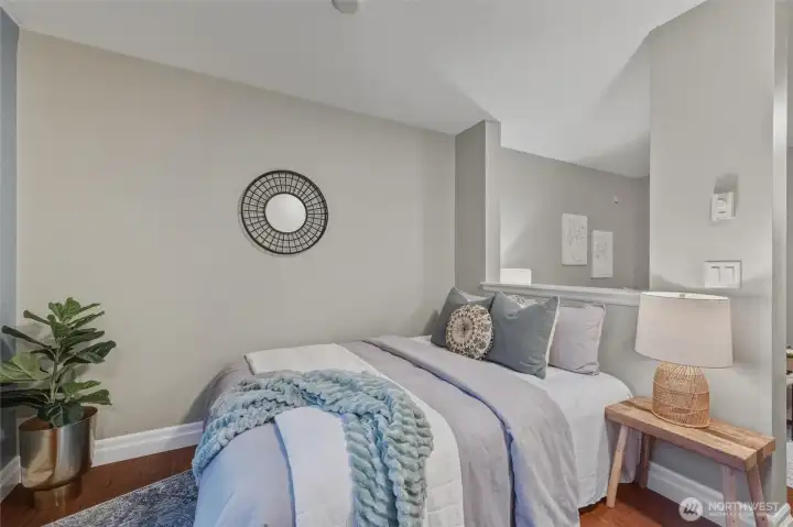 A clever partial wall creates a cozy sleeping nook that feels distinct yet open. Generous closet space and soft natural light make this studio layout both practical and serene.