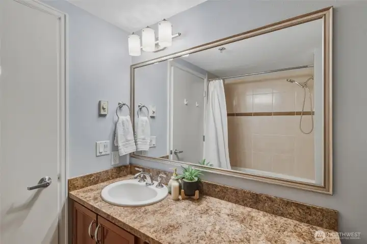 Enjoy a full bath with modern fixtures, plenty of counter space, and attractive built-in shelving. Clean, bright, and move-in ready.