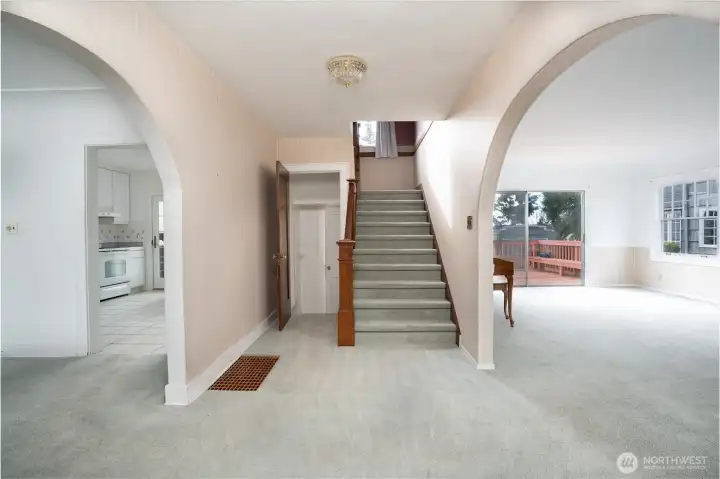 Welcome.  To the right is the large living room, to the left is the dining room and kitchen, to the left of the staircase is a half bath and the stairs to the unfinished basement.