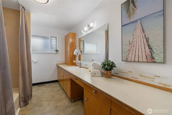 Lare hall bathroom has built in vanity.