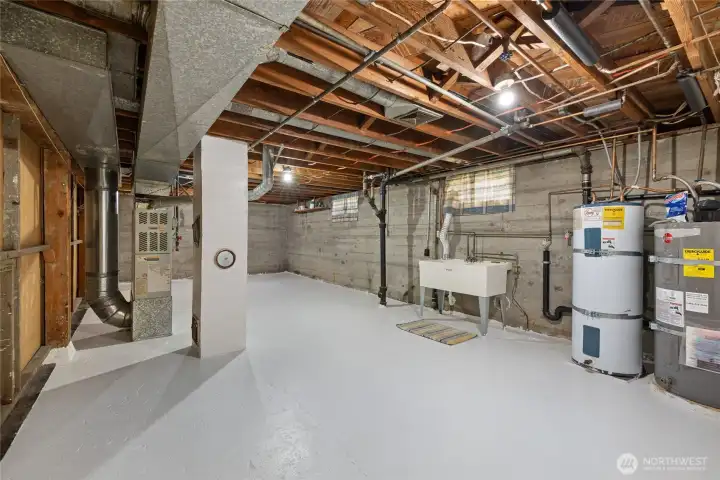 Main part of basement with laundry hook ups.