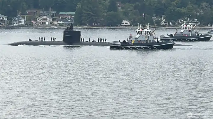 Watch the submarines as they are escorted out to sea.