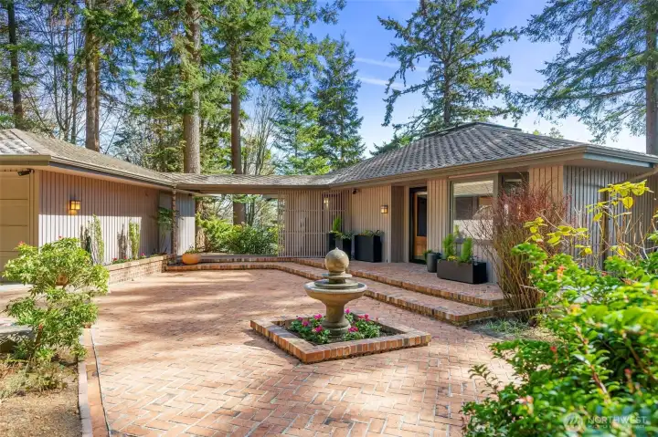 Front entrance view with classic brick patio and breezeway connecting the garage to kitchen door Front entrance view with classic brick patio and breezeway connecting the garage to kitchen door