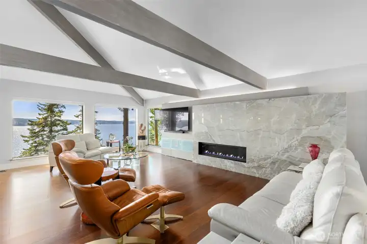 Living room with huge picture windows inviting in the stunning ever changing water views and light. Can you believe that massive Quartzite stone fireplace! This home was completely and tastefully remodeled by the current owners with no expense spared. Living room with huge picture windows inviting in the stunning ever changing water views and light. Can you believe that massive Quartzite stone fireplace! This home was completely and tastefully remodeled by the current owners with no expense spared.