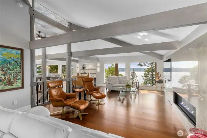 Structural strength/architecture indicated by the solid fir posts and beams span the main floor in all directions. Natural light fills the living room and reflects off the amazing wall of custom quartzite fireplace and warm bamboo floors. Structural strength/architecture indicated by the solid fir posts and beams span the main floor in all directions. Natural light fills the living room and reflects off the amazing wall of custom quartzite fireplace and warm bamboo floors.