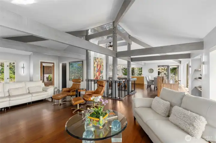 View from living room through the center staircase into the kitchen and dining area. Big structural Fir beams dominate with strength and beauty View from living room through the center staircase into the kitchen and dining area. Big structural Fir beams dominate with strength and beauty