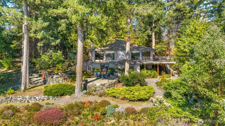 Drone shot from over the water below- tucked into a private little corner on 1.47 acres of waterfront. Drone shot from over the water below- tucked into a private little corner on 1.47 acres of waterfront.