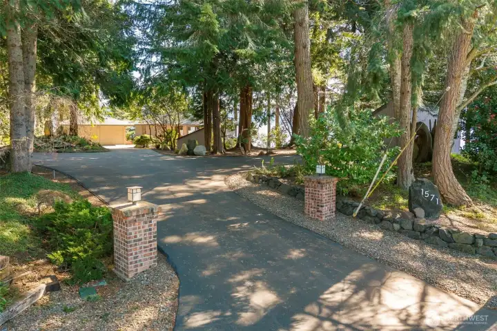 Brick pillars guard the entrance to this secluded little haven on Hood Canal. It would be possible to gate the entrance if desired. Brick pillars guard the entrance to this secluded little haven on Hood Canal. It would be possible to gate the entrance if desired.