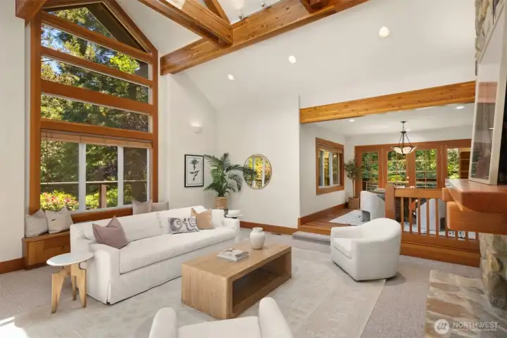 There are two living rooms, one on the east side of the home, the other on the west side. Both have striking vaulted ceilings with exposed beams, skylight, transoms and river rock fireplaces.