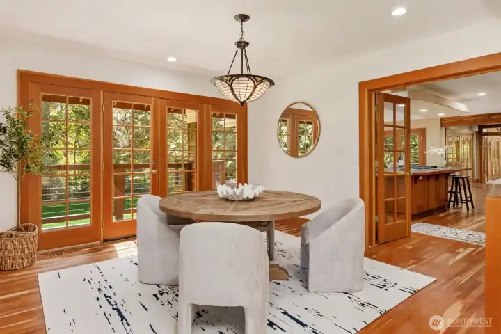 The dining room with French doors garden deck and French doors to the kitchen on the right.