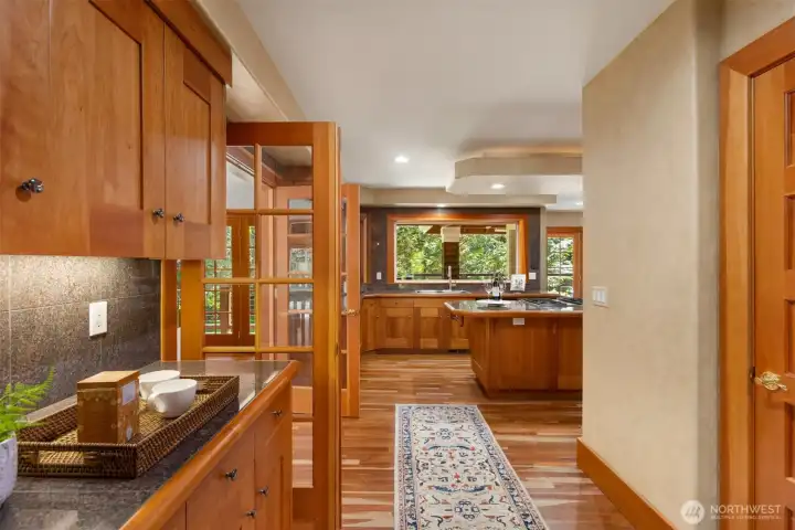 View from the entryway through the French doors to the kitchen.