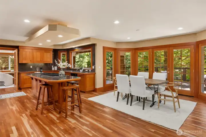 In-kitchen dining with a wall of windows and a French door to the deck. Seamless indoor/outdoor living - morning coffee, peaceful dinners, summer breezes, parties!