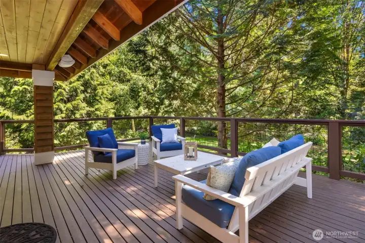 The covered deck wraps around almost the entire home to the front door!
