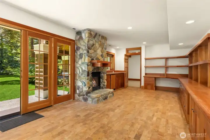 The lower level has a total of four rooms. This is the east room with its own private entrance, a fireplace, wet bar, cherry built-ins and new cork floors. Perfect for guests with a 3/4 bathroom.
