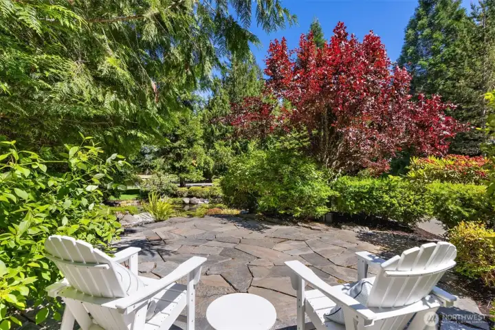 The patio overlooking the waterfall and pond with a view to the riding arena in the distance.
