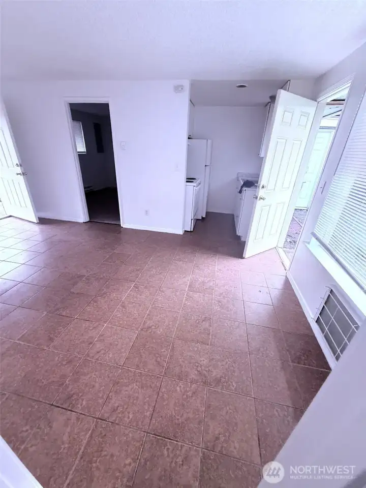 interior file photos of 1644 prior to rental of entry and living area and kitchen