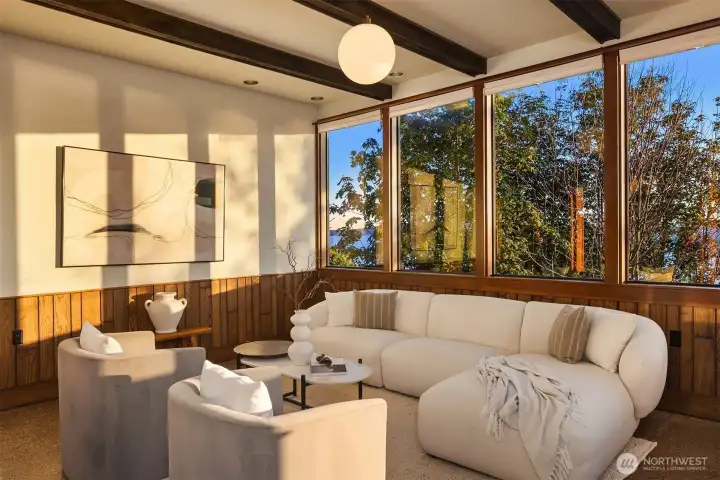 Retreat in this cozy room filled with natural light. Here beamed ceilings & wall of picture windows. Retreat in this cozy room filled with natural light. Here beamed ceilings & wall of picture windows.