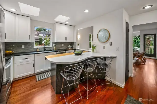 Open concept kitchen with French marble peninsula and bar seating