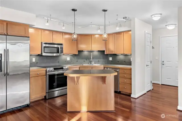 Island kitchen with newer Stainless Steel appliances.