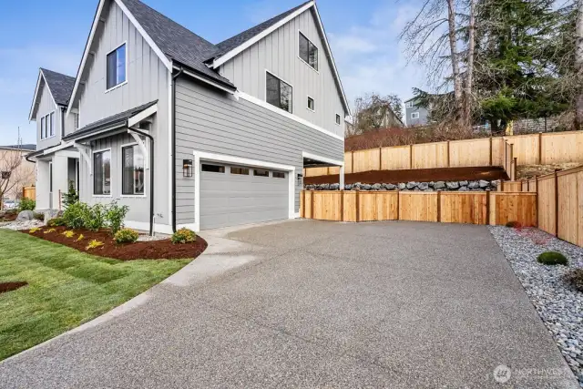 Side load garage offers extra parking and added space between the neighboring home.