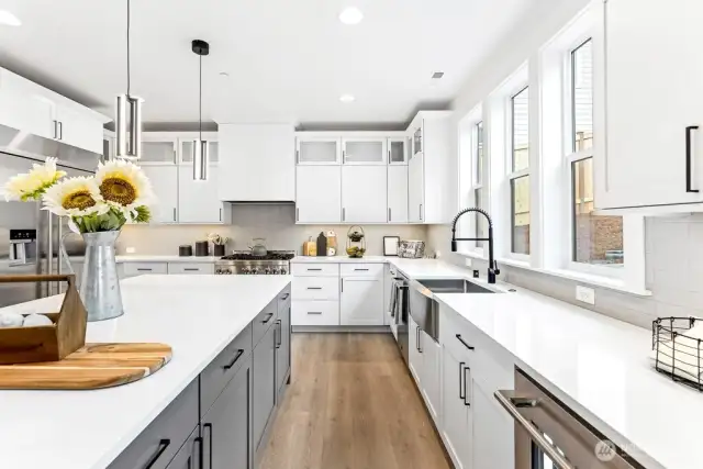 JennAir Rise appliances, deep farmhouse sink, and touchless faucet.