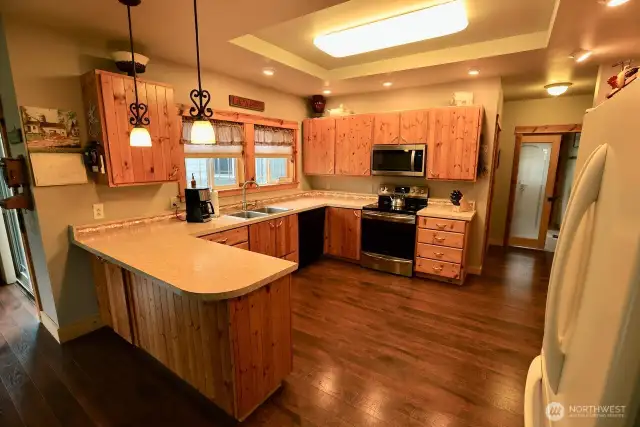 The kitchen is the heart of this home.  Custom knotty pine cabinets and a great layout are a must see.