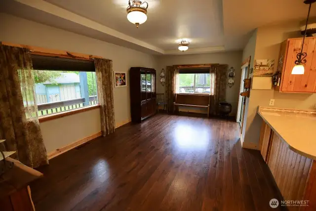 The spacious dining room with coffered ceiling, natural light, and creates a wonderful hub to this country home.