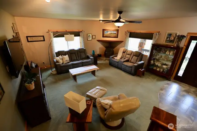 Country charm, natural light, ceiling fan, and pellet stove make a great living room