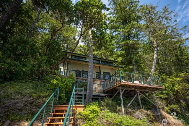 View of home from lower deck. The 1,000 Sqft of decking give the option to Take is the sun or hideaway in the shade.