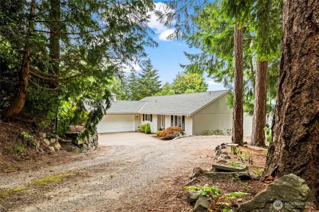Tucked back from the road, this private driveway winds through a forested landscape—revealing a hidden retreat surrounded by nature and set on 1.18 acres.