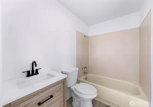 New toilet and vanity. Mirror being installed