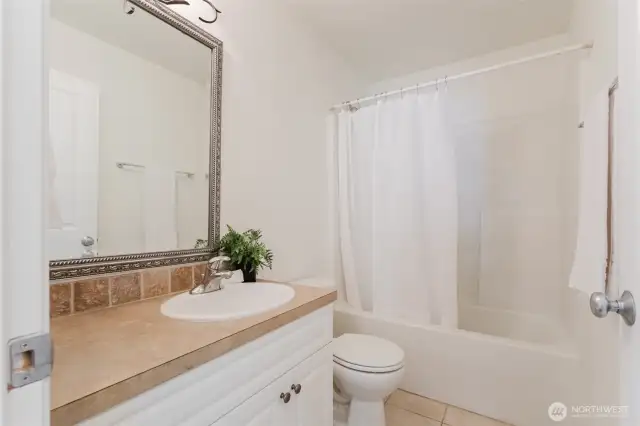 Full main bathroom with a tub