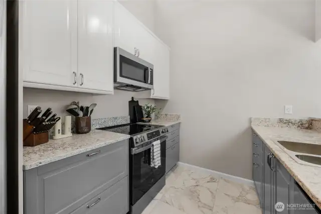 remodeled kitchen with quartz countertops and tile flooring-cabinets are soft close and appliances are all new as well