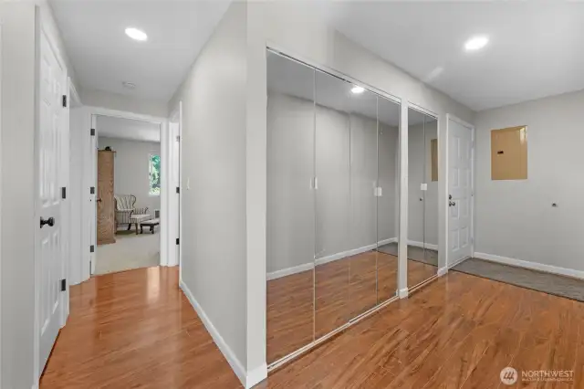 entrance hallway and hallway to bedrooms-washer and dryer are located behind the glass closet doors