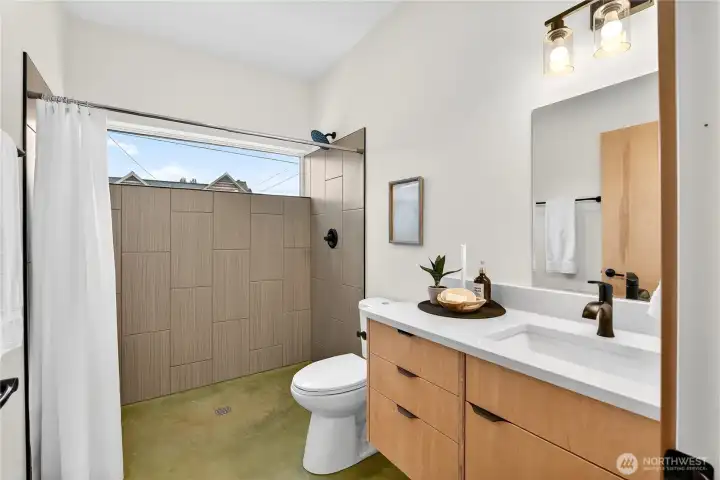 Main floor bathroom feature zero barrier shower entry.