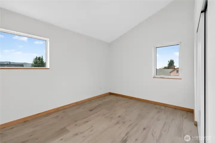 One of the four upstairs bedrooms (empty to show ample space and light.)