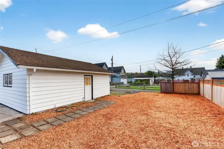 The side yard and detached garage/shop space.