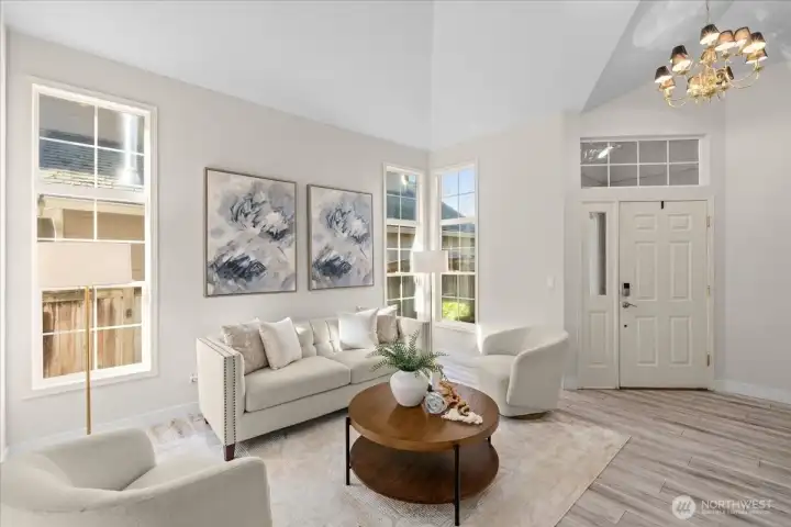 Step inside to appreciate the living room with cathedral ceilings and flooded with natural light