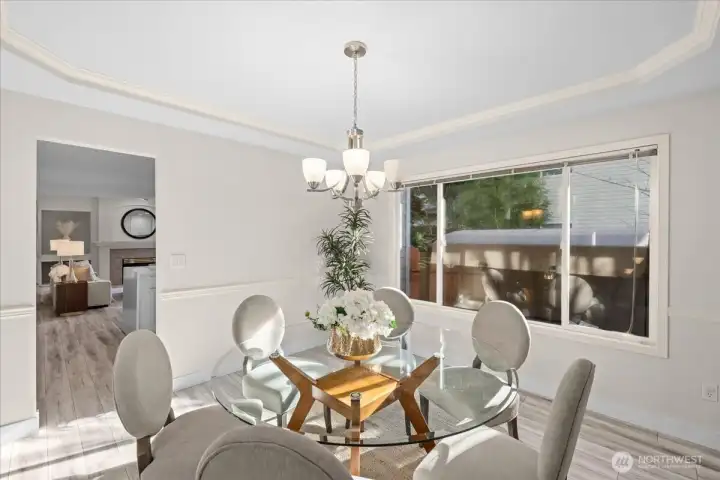 The dining room features a tray ceiling and moulding