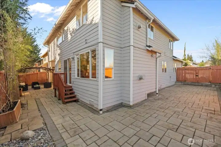 Relax in the low maintenance backyard with custom stone paver blocks. The huge side yard gives you extra space to play or use for storage.