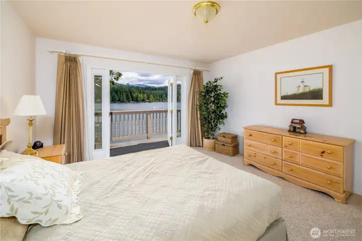 Bedroom with private balcony and spacious closet.
