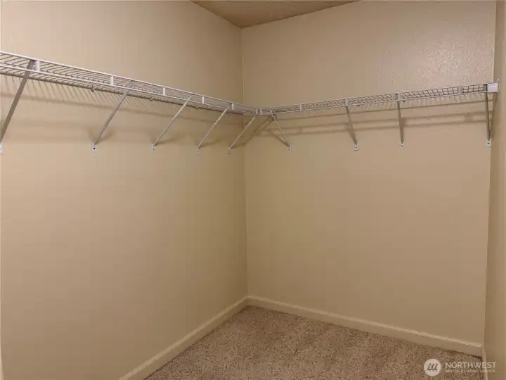 Primary bedroom walk in closet